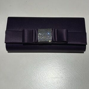 Dark purple satin evening clutch with crystal bow detail